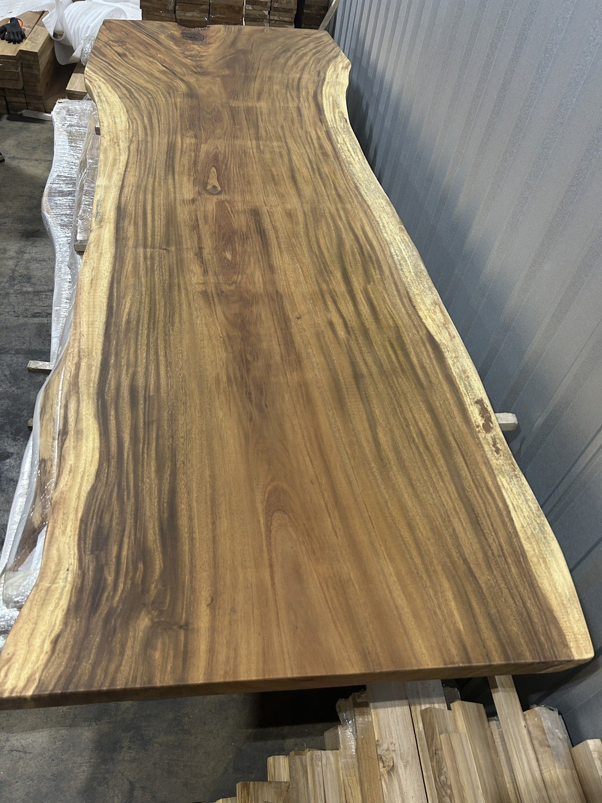 Slab No. 01, first face — the actual 10 ft single-slab Saman monkeypod top, matte lacquer finish, photographed in our Lincolnwood IL warehouse