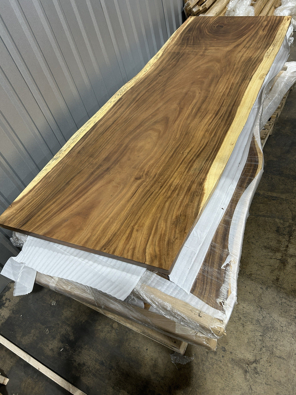 Slab No. 17 at an angle showing the 2.5 in slab thickness and full 8 ft 4 in length — actual piece, Platinum Luxury Teak, Lincolnwood IL