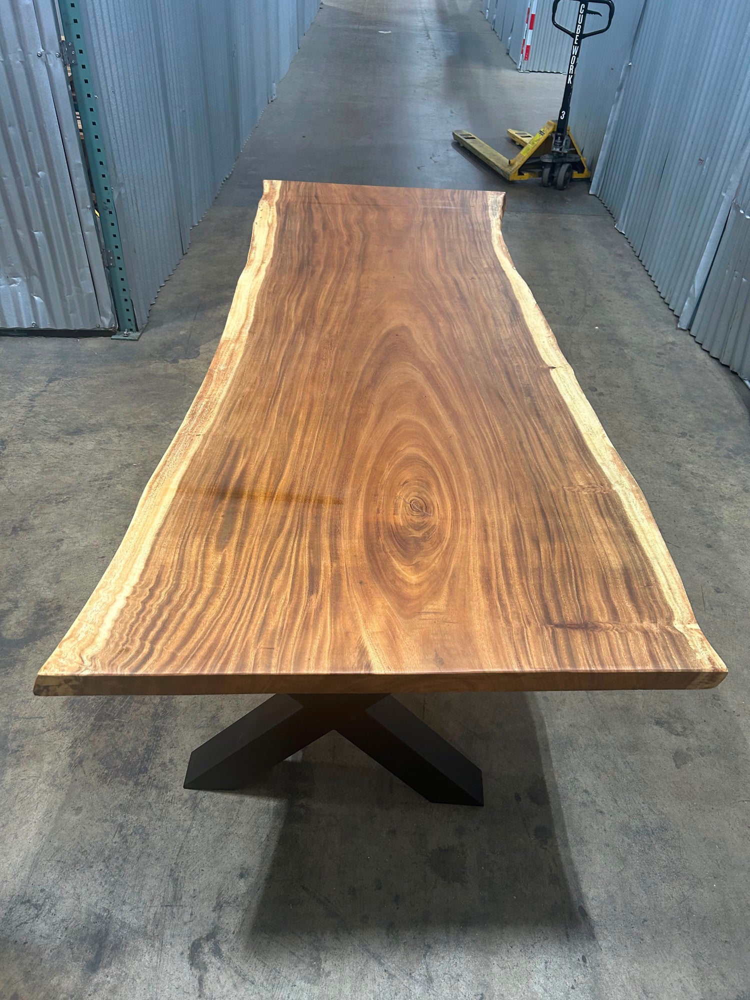 Finished single-slab Saman monkeypod live-edge table on powder-coated steel base, in stock at our Lincolnwood IL warehouse — Platinum Luxury Teak