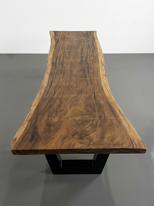 Slab No. 05: 10 ft single-slab Saman (monkeypod) live-edge boardroom table on a black steel base, on a white background. This photo identifies the listing; warehouse photographs of the slab follow.