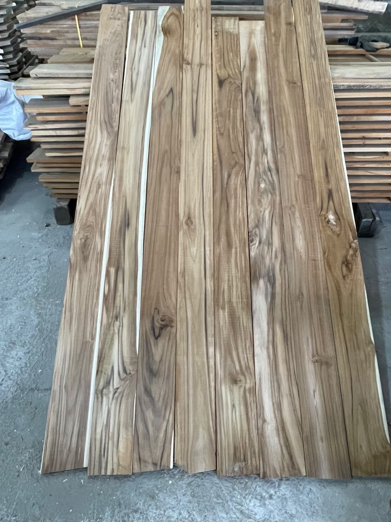 Ecuadorian teak boards laid side by side showing grain and heartwood colour — Platinum Luxury Teak, Lincolnwood IL