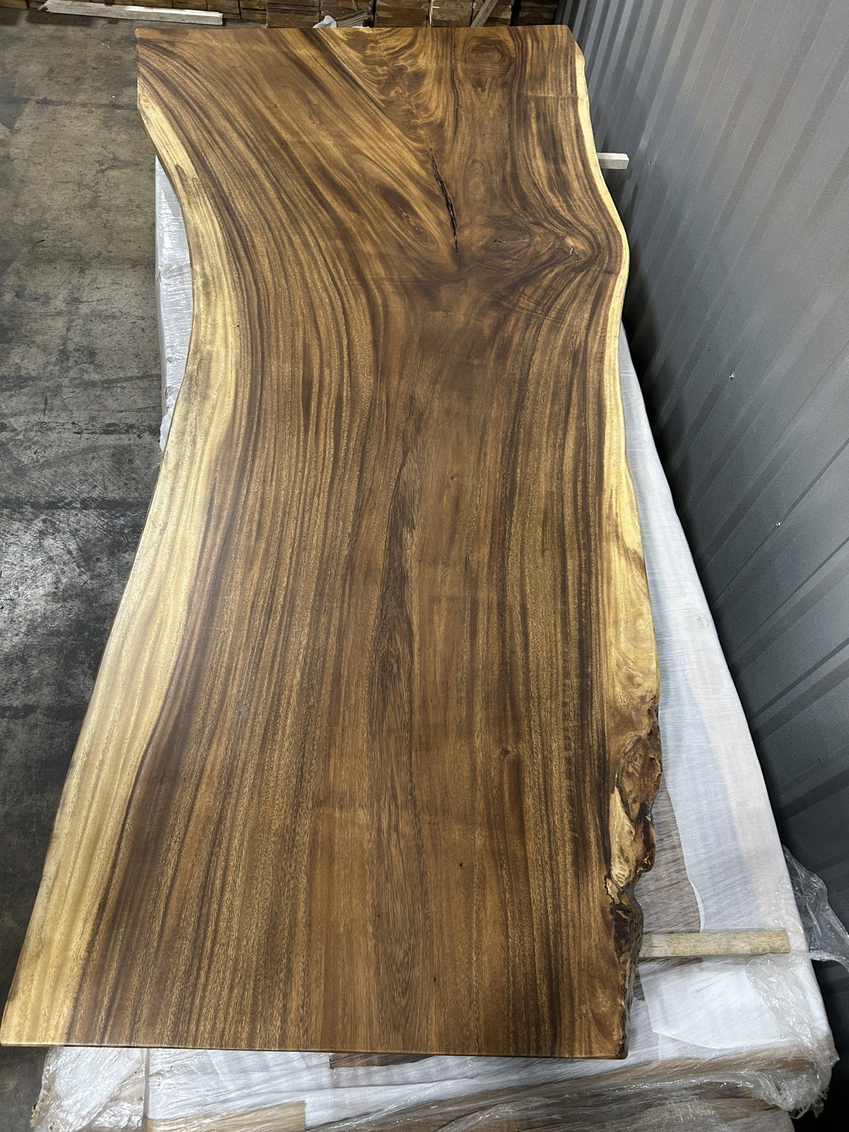 Slab No. 11, first face — the actual 8 ft single-slab Saman monkeypod top, matte lacquer finish, photographed in our Lincolnwood IL warehouse