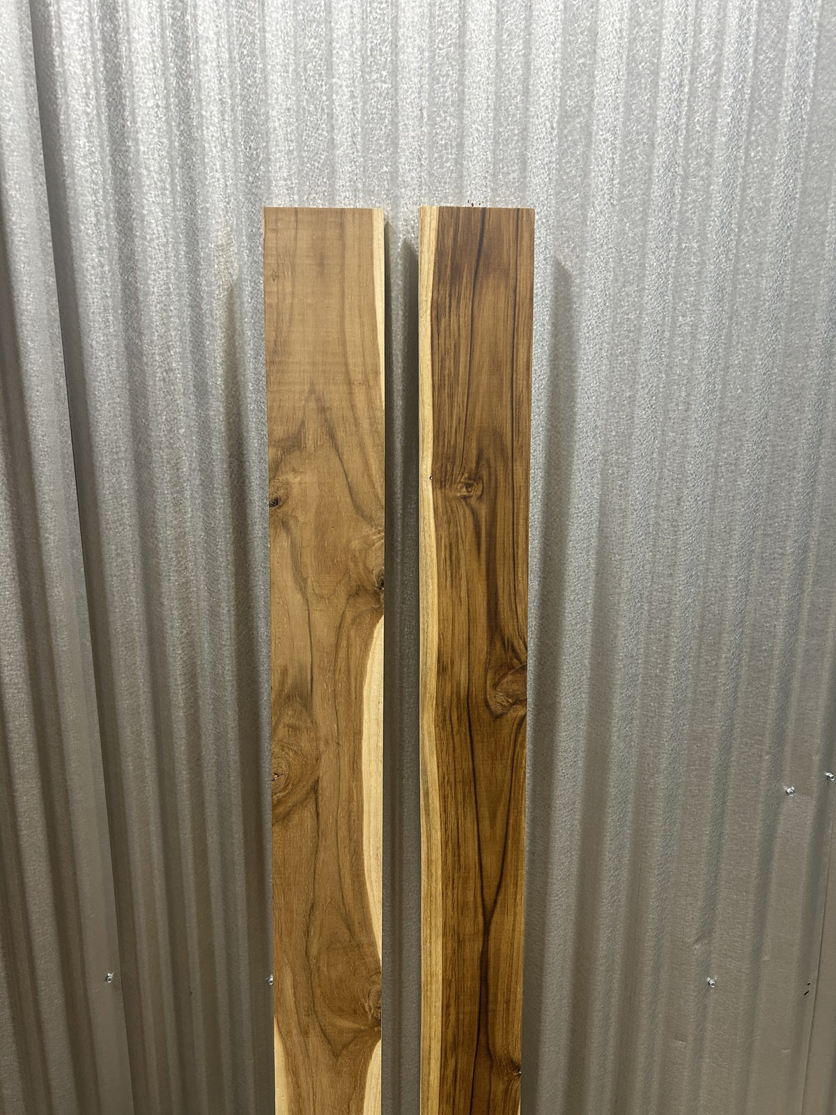 Two short Ecuadorian teak boards standing: left as it ships, right with one wipe of oil — Platinum Luxury Teak, Lincolnwood IL