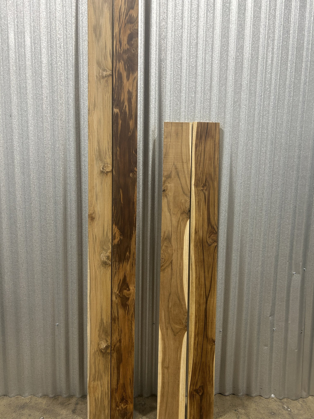 Two pairs of Ecuadorian teak boards standing: in each pair, one as it ships and one with a wipe of oil — Platinum Luxury Teak, Lincolnwood IL
