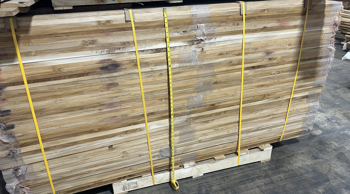 Banded pallet of Ecuadorian teak lumber with a tape measure showing stack height — Platinum Luxury Teak, Lincolnwood IL