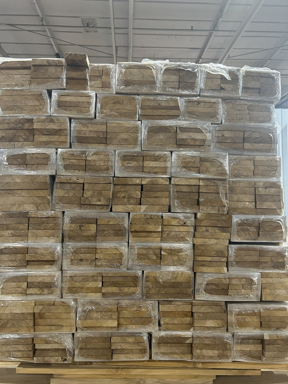 Packet ends of banded Ecuadorian teak narrow stock, 2 to 4 in wide, stacked on a pallet — Face-Frame and Edge-Banding Teak inventory, Platinum Luxury Teak, Lincolnwood IL