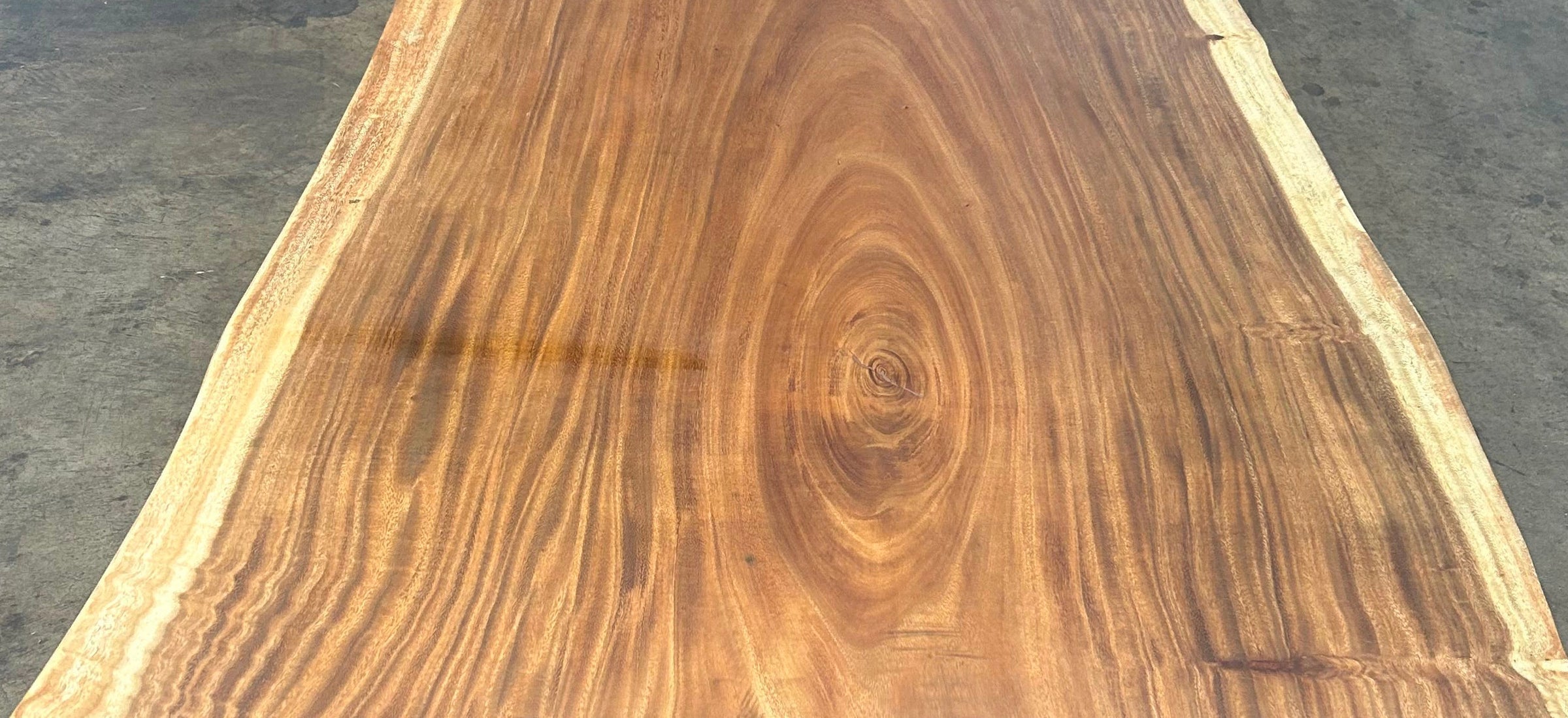 Single-slab Saman monkeypod live-edge table top, figured grain across the full width — Platinum Luxury Teak, in stock in Chicago